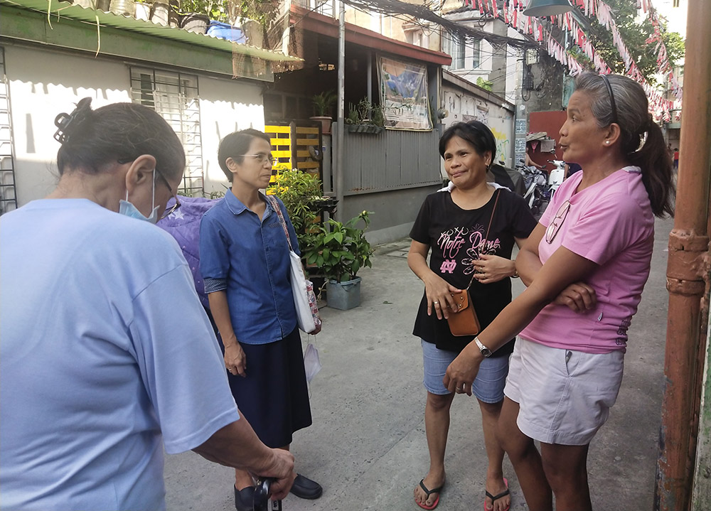 From left: Sister Jane, Sister Arabella, Recy and Francia on the streets in Paco, Manila, Philippines, on Sept. 2, 2023 (Jerahmeel Cruz)
