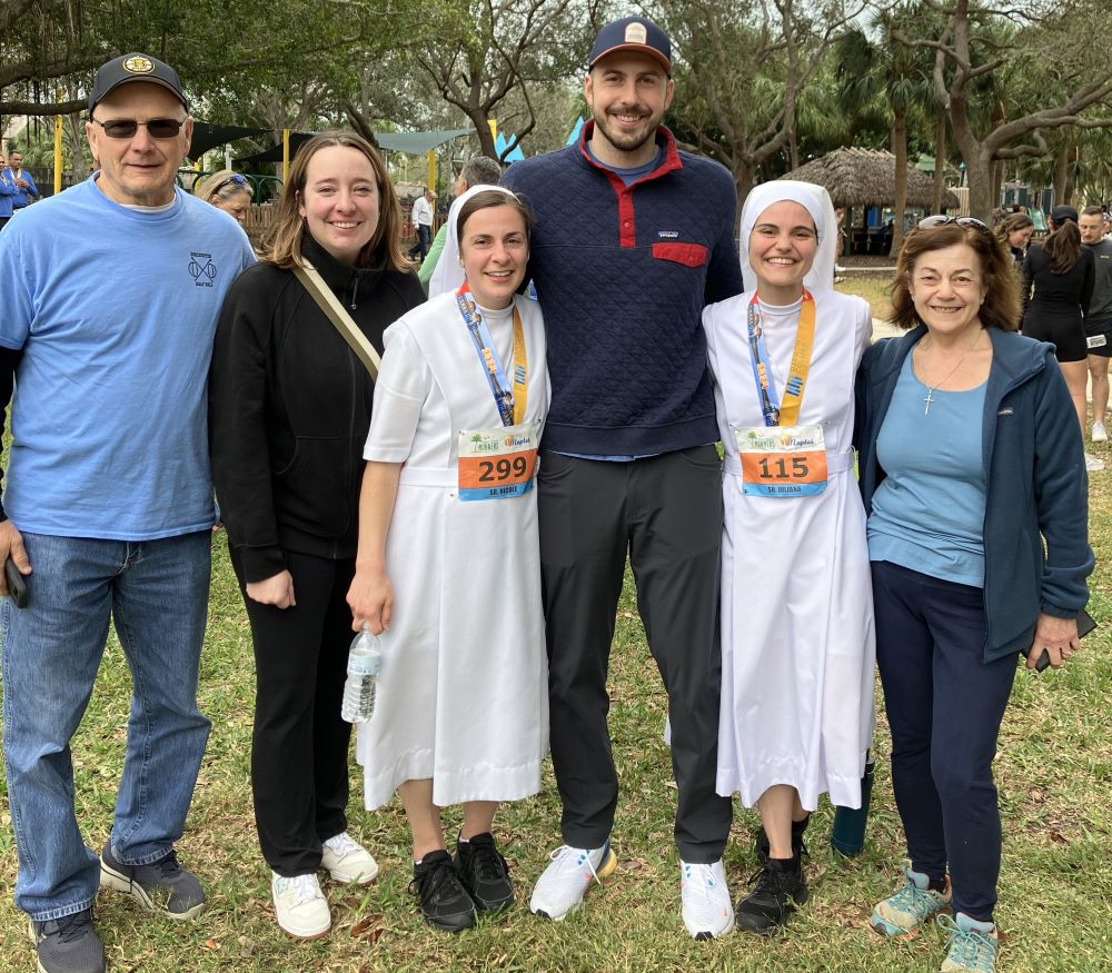 Sr. Nicole Daly, third from left, stands with her father, sister-in-law, brother, running buddy Sr. Juliana Alfonso and her mother. The Dalys traveled from Boston to witness the consecrated religious sisters compete in the Barron Collier Companies Naples Half Marathon Jan. 14. (OSV News/Nicole Daly/Courtesy of Salesian Sister of St. John Bosco)