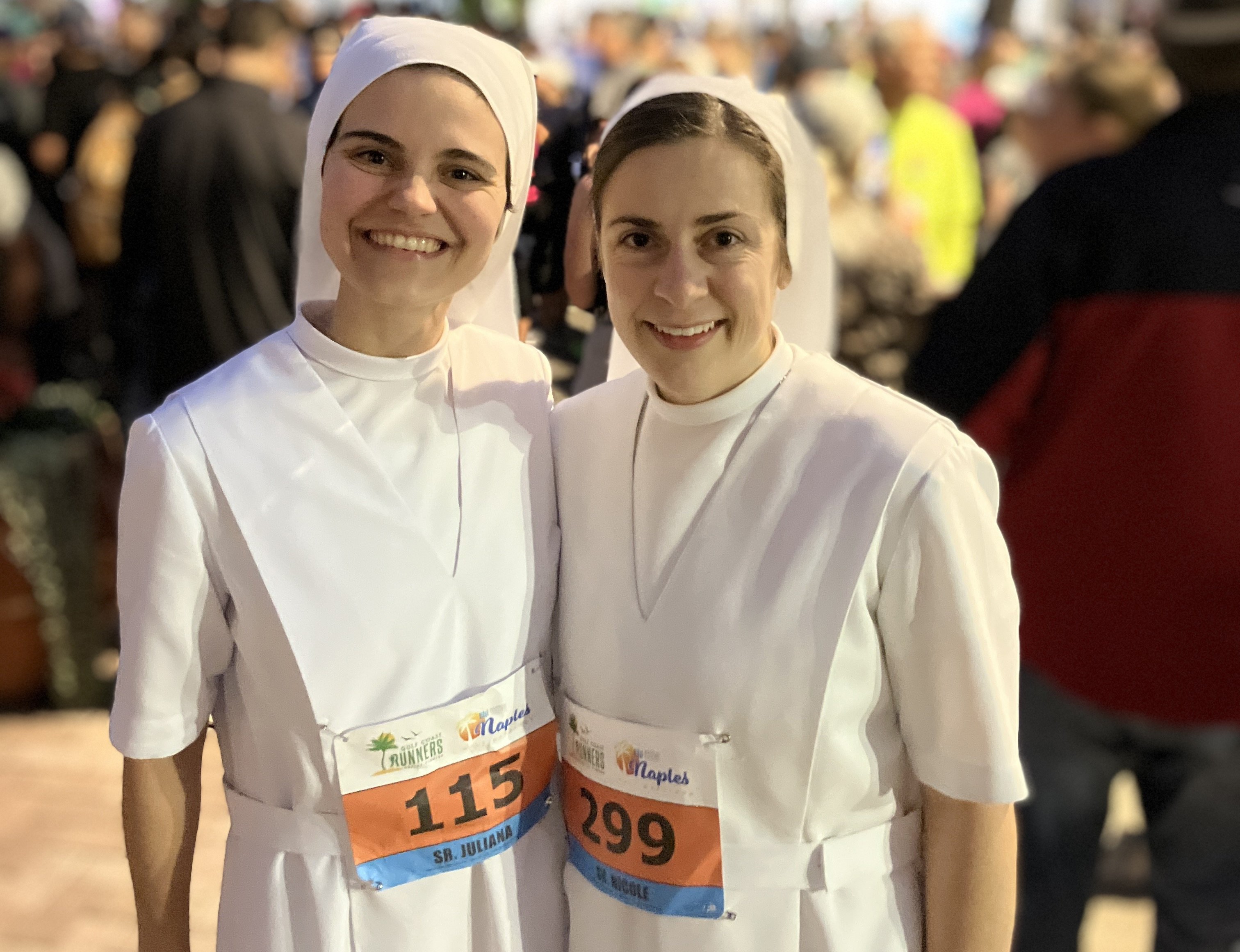 Srs. Juliana Alfonso and Nicole Daly share a smile before starting their 13.1-mile half marathon in Naples, Florida, Jan. 14, wearing full habits.