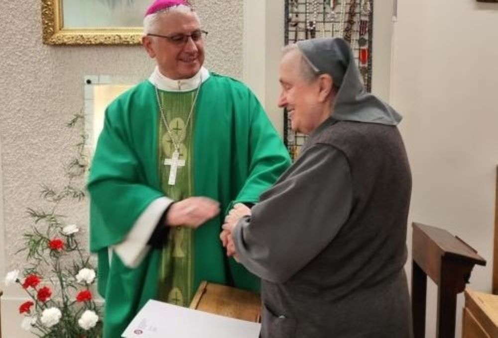 Mother Jolanta Olech appears at a Thanksgiving Mass for her retirement in Warsaw on Nov. 14. With her is Bishop Artur Mizinski.