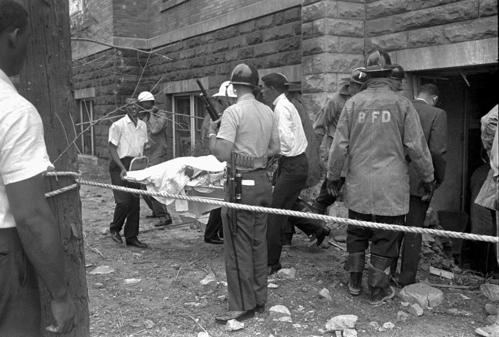 Firefighters and ambulance attendants remove a covered body from the 16th Street Baptist Church in Birmingham, Ala., Sept. 15, 1963, after a deadly explosion detonated by members of the Ku Klux Klan during services.