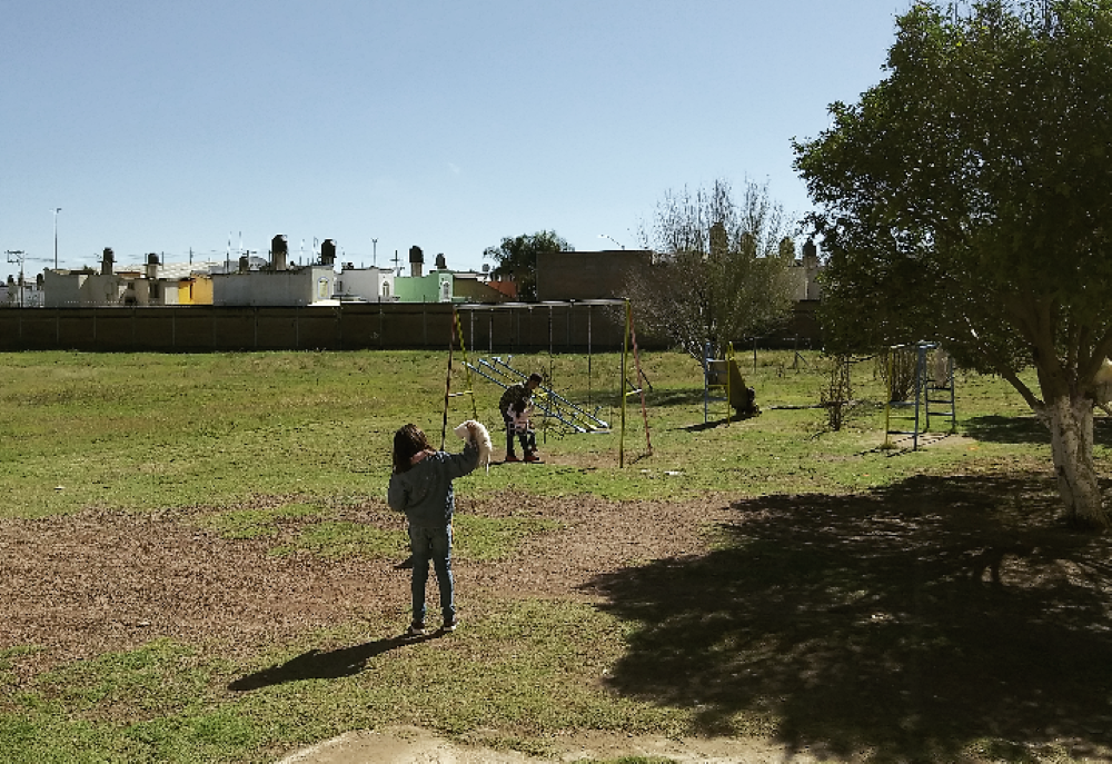 5. Three children staying at Casa Hogar Franciscana play outside on a sunny, cold November morning.