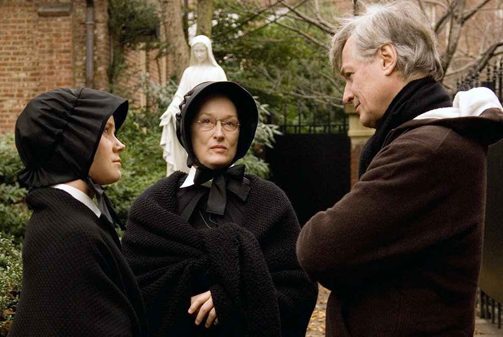 Amy Adams and Meryl Streep talk with writer-director John Patrick Shanley on the 2009 set of the movie "Doubt." (CNS/Miramax) 