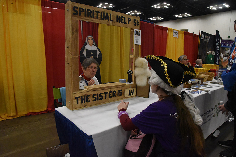 Sr. Marilyn Baker, a member of the Sisters of Providence of Saint Mary-of-the-Woods in western Indiana, talks with Maddie Kervick of the Diocese of Springfield, Massachusetts, on Nov. 16, 2023, in the Indiana Convention Center in Indianapolis. They were there for the National Catholic Youth Conference, a biennial event that draws 12,000 Catholic teenagers from across the country. (OSV News/The Criterion/Sean Gallagher)