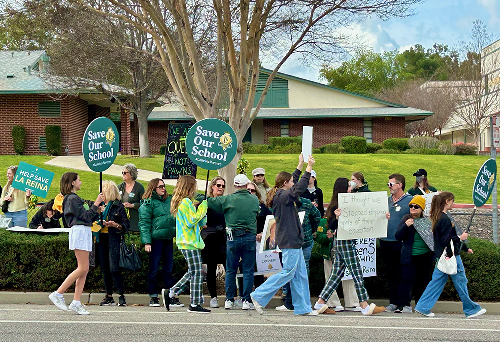 Protest participants display signs outside the grounds of La Reina Feb. 3 in Thousand Oaks, California. The protest was organized by the Save La Reina group to prevent the closure of La Reina, a high school and middle school run by the Sisters of Notre Dame. (Tom Hoffarth)