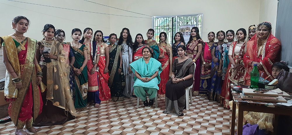 Sr. Anita Bandod is pictured with young women trained in beautician courses, displaying their efficiency in bridal makeovers. In response to the incidents of human trafficking, Missionary Sisters Servants of the Holy Spirit initiated skill training programs based on current trends, like the beautician courses. (Courtesy of Tessy Jacob)
