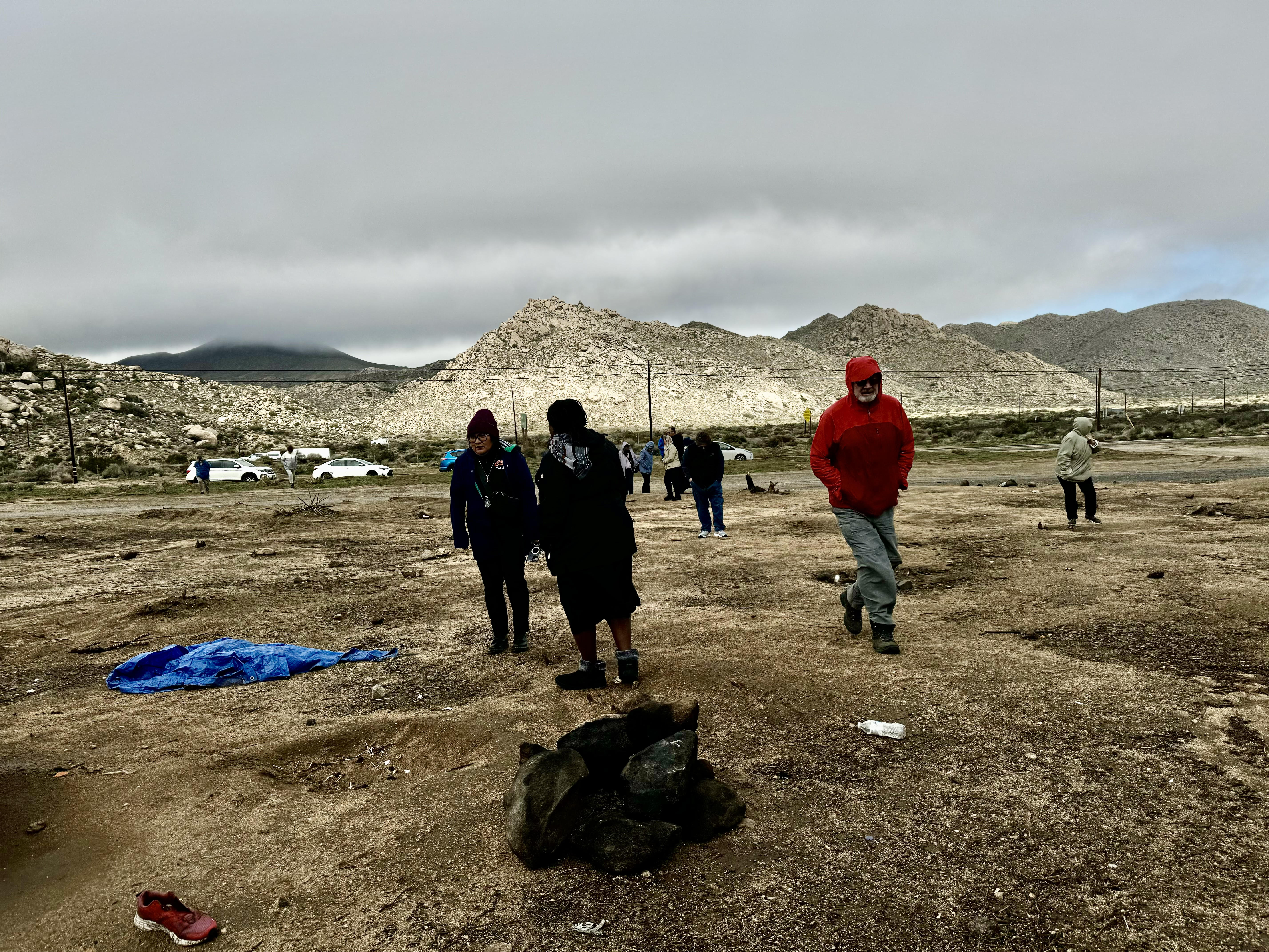 A group of women religious, along with a priest and a Franciscan friar, stop by an abandoned camp in the desert, near Jacumba Hot Springs, south of San Diego, Feb. 7. Some prayed near the shoes, tattered tents and wet sleeping bags left behind where migrants sought shelter from the cold rain and snowstorms affecting the San Diego region this winter. (GSR photo/Rhina Guidos) 