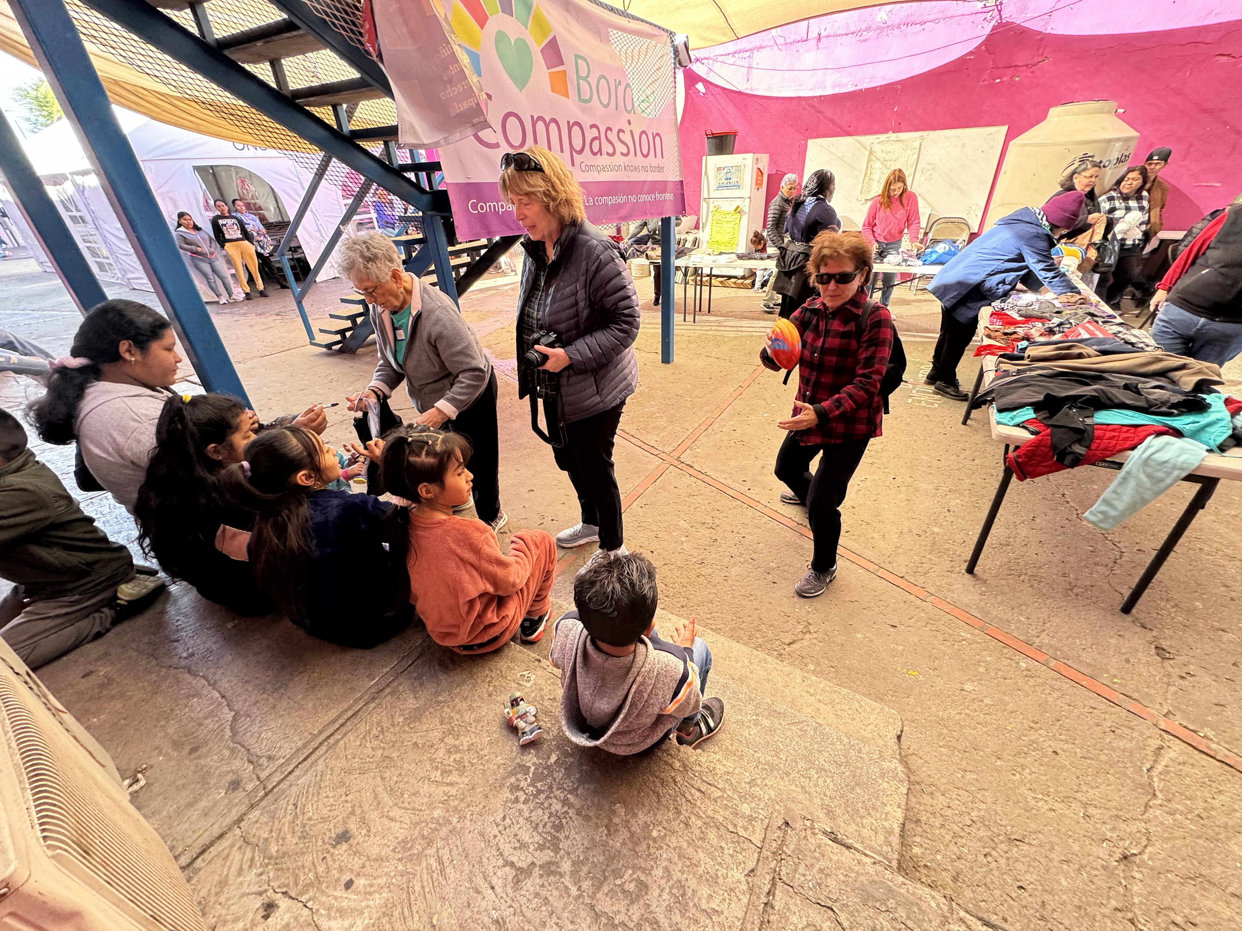 Sr. Carol Selak, right, plays with a child as other sisters greet migrants at the Cobina Posada del Migrante Shelter Feb. 8 in Mexicali, Mexico. Selak, of the Sisters of the Holy Name of Jesus and Mary in California, was part of a five-day pilgrimage discerning the role of religious communities at the U.S.-Mexico border. (GSR photo/Rhina Guidos)
