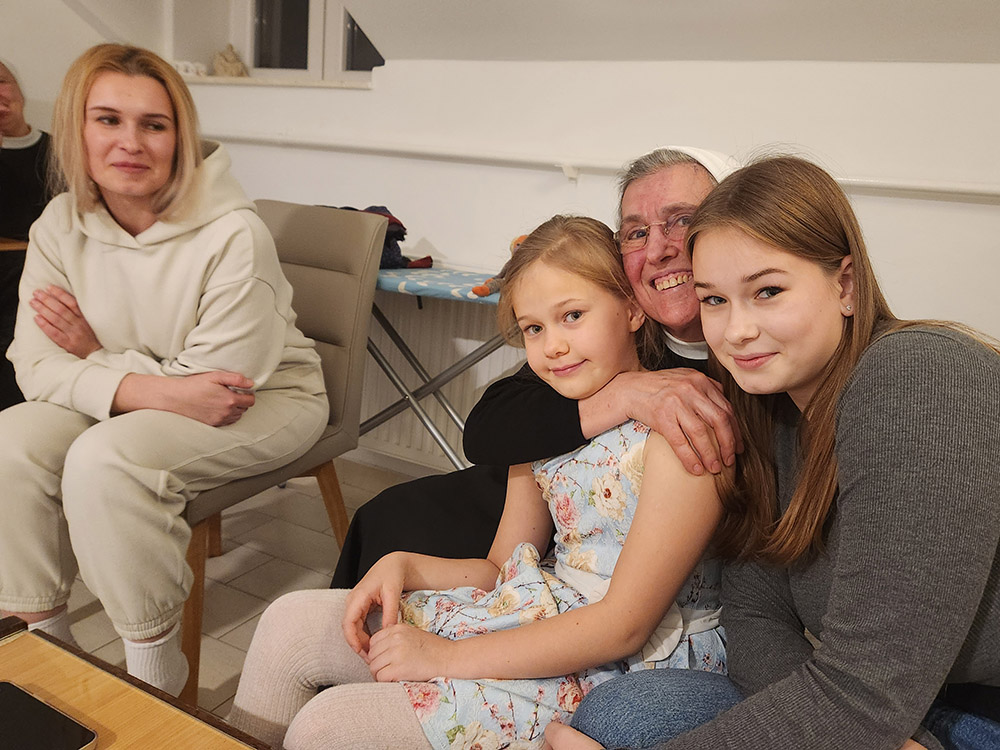 Sr. M. Franka Odrljin, center, a member of the Sisters of Charity of Zagreb in Croatia, with members of the Ouchynnikova family, who have settled in the coastal city of Split, living in a convent space provided by the sisters.  Maria, 37, the mother, is at left with daughters 16-year-old Sofia, right, and 8-year-old Anastasia, center. Odrljin is the director of the sisters' Split refugee ministry.