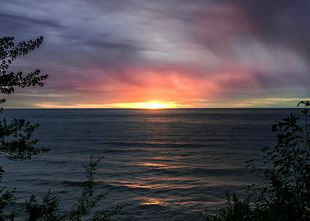 A view from Michigan of a sunset on Lake Superior (Unsplash/Alan Labisch)