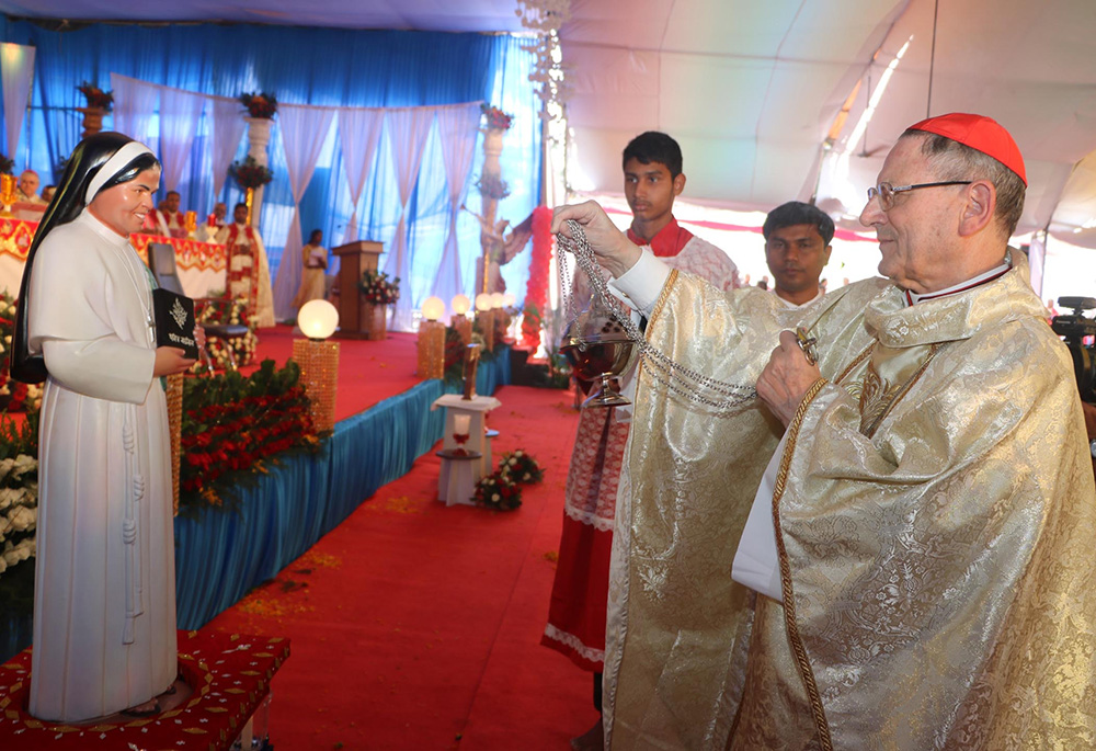 Cardinal Angelo Amato, prefect of the Congregation for Saints' Causes, blesses the statue of Clarist Sr. Rani Maria Vattalil following her Nov. 4, 2017, beatification Mass in Indore, India. Sister Rani Maria was stabbed to death in 1995. (CNS/Anto Akkara)