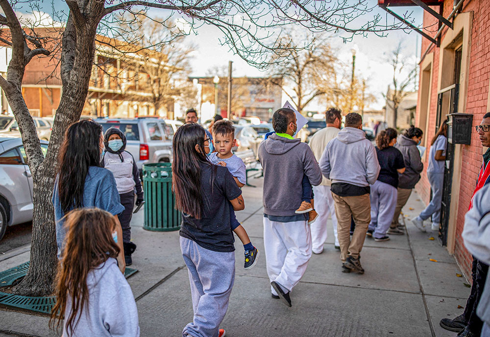 A family of migrants is dropped off by a transport contractor for the U.S. Customs and Border Protection at a shelter run by Annunciation House in downtown El Paso, Texas, Dec. 13, 2022. A state judge blocked the Texas attorney general's demands for the records of Annunciation House March 11, 2024, citing concerns the state had a "predetermined" motive to shut down the Catholic nonprofit serving migrants. (OSV News/Reuters/Ivan Pierre Aguirre)