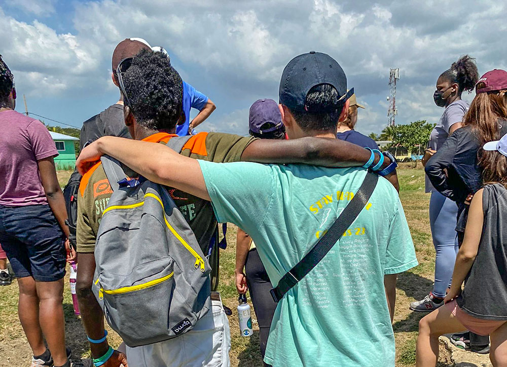 A resident of Jamaica Mustard Seed in Kingston, Jamaica, and a student from the Boston College mission group form a heartwarming friendship. (Ana González)