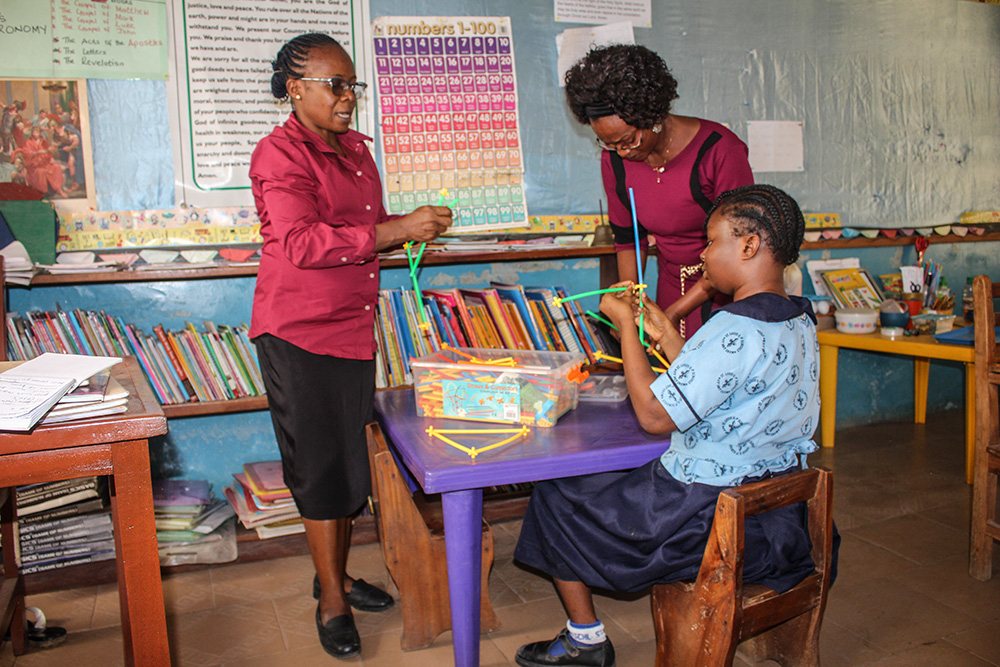 Philomena Ekwe (left), one of the teachers at St. Louis Nursery and Primary School, Akure, constructs shapes using colorful straws. The school is a community-based rehabilitation center where the Sisters of St. Louis provide holistic intervention for persons with disabilities. (GSR photo/Valentine Benjamin)