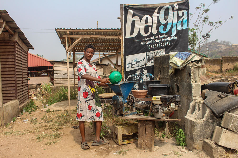 Fehintola Odeyemi struggles with physical mobility and speech and hearing disabilities. The Sisters of St. Louis provided a petrol-powered grinding machine to enable her to generate personal income. (GSR photo/Valentine Benjamin)