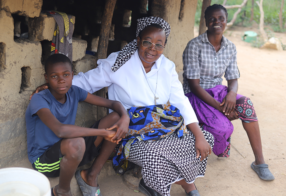 Sr. Matilda Mubanga visits Ella Daura at her home in Chibombo, a town in the central region of Zambia, on March 11. (Doreen Ajiambo)