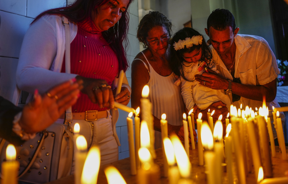 Virgin of Charity Devotees light candles at shrine of the Virgin of Charity in El Cobre, Cuba.