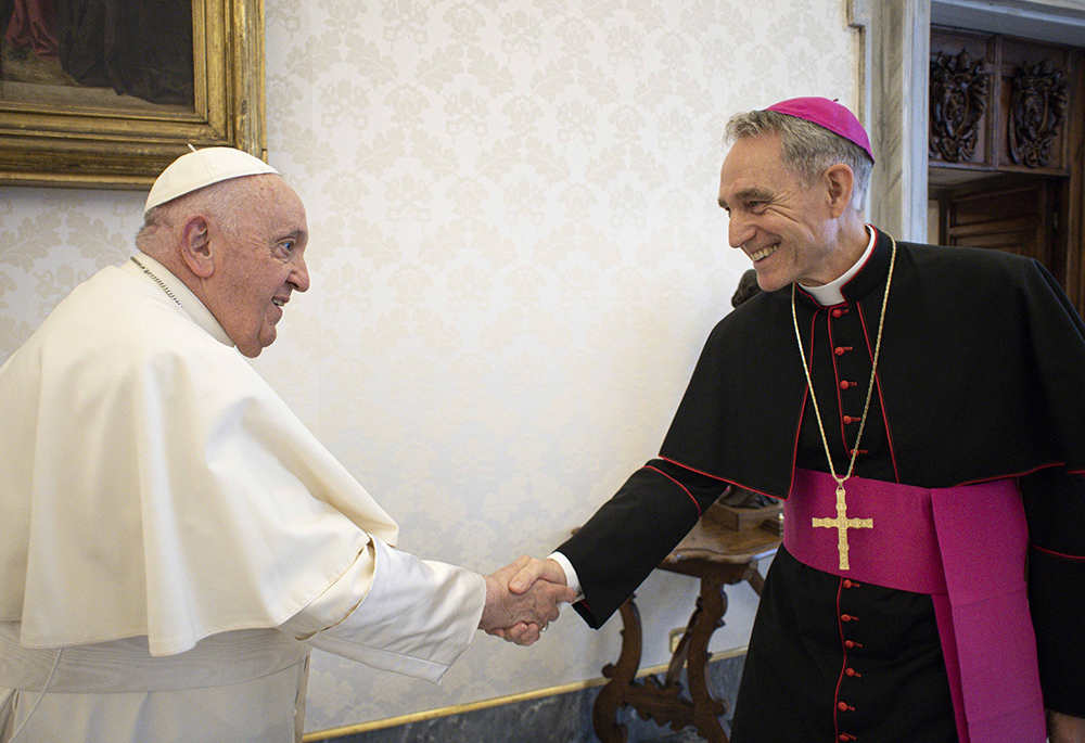 Pope Francis meets Archbishop Georg Gänswein, personal secretary to the late Pope Benedict XVI, in the library of the Apostolic Palace at the Vatican May 19, 2023. Although he still has the title of prefect of the papal household, Gänswein has not worked in the office since 2020 and is awaiting a new assignment. (CNS/Vatican Media)