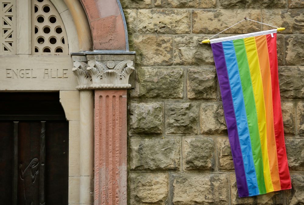 A rainbow flag is seen on the wall of a Catholic church in Cologne, Germany, May 10, 2021.