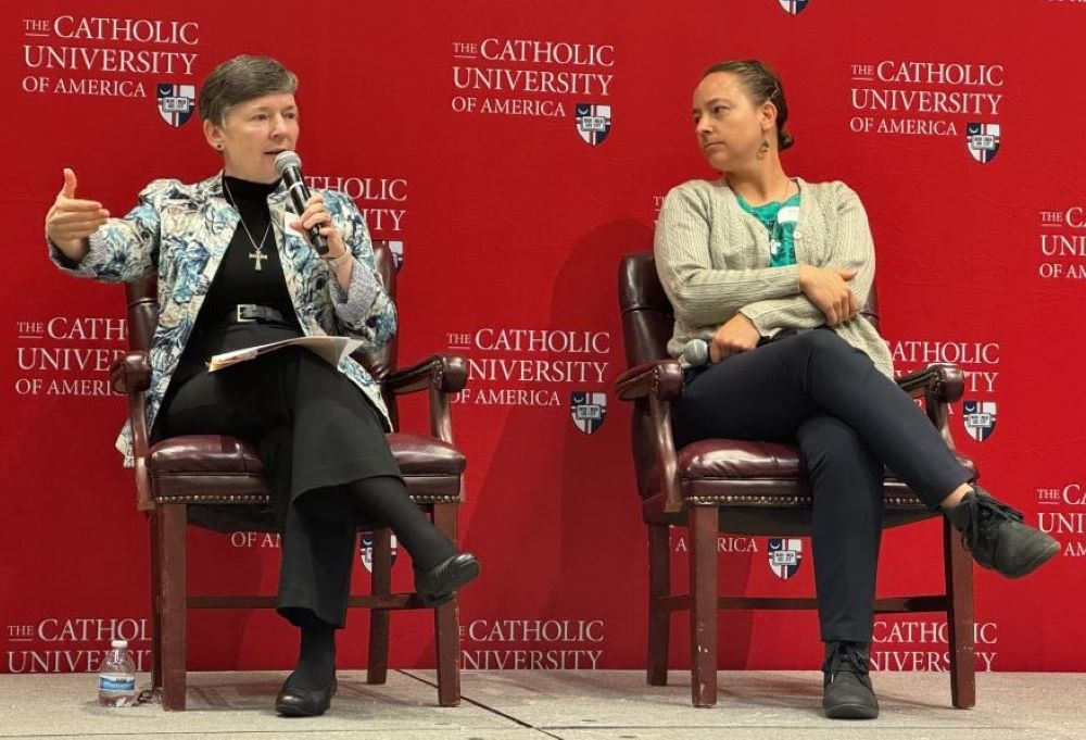 Holy Cross Sr. Sharlet Wagner, left, talks about the Catholic Church's work with migrants and refugees, as Sr. Tracey Horan, of the Sisters of Providence of St. Mary-of-the-Woods, looks on. 