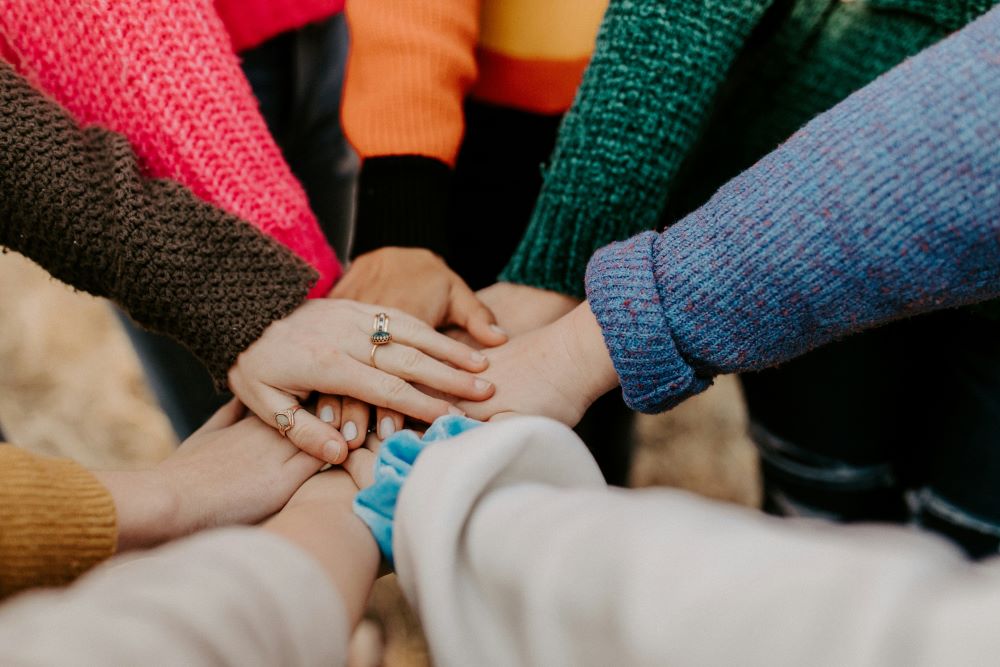 group of people with hands placed on top of each other