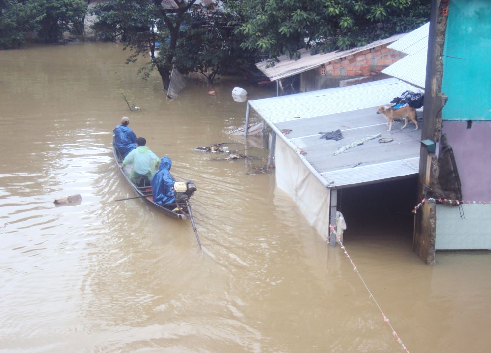 People travel by boat through floodwater in Quang Dien district of Thua Thien Hue province, Vietnam, Nov. 17.