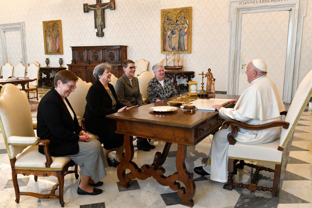 Pope Francis shares a laugh with officers of the U.S. Leadership Conference of Women Religious during a meeting in the library of the Apostolic Palace at the Vatican March 21, 2024. 