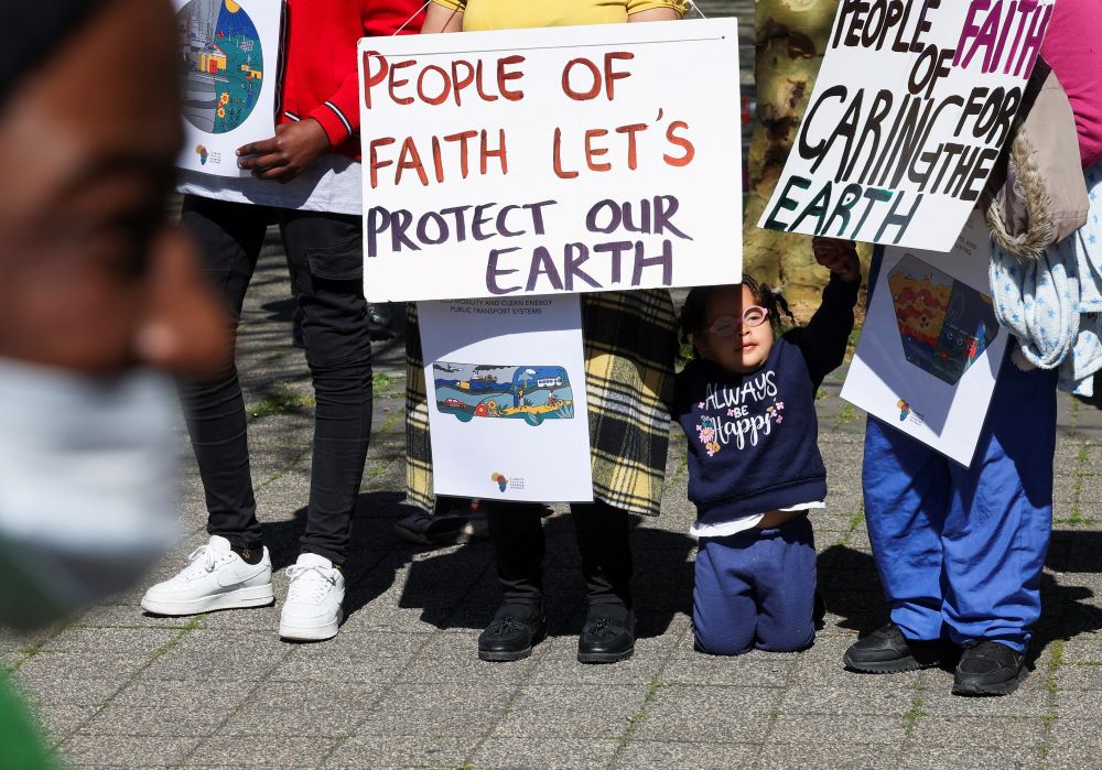 Climate activists in South Africa hold placards as they gather outside the Cape Town International Convention Center Sept. 13, during the Southern Africa Oil and Gas Conference to call for climate justice resistance against oil and gas corporations and an end to fossil fuels.