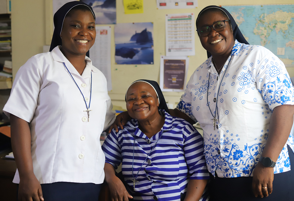 Srs. Angela Mbalu Bangura (right), Elisabeth Asare Buobi (center) and Christiana Fefegula pose for a photo at St. Joseph Primary School in Freetown, the capital of Sierra Leone. Bangura says that as a leader, she delegates duties to other sisters to help her if she cannot reach everybody. (GSR photo/Doreen Ajiambo)