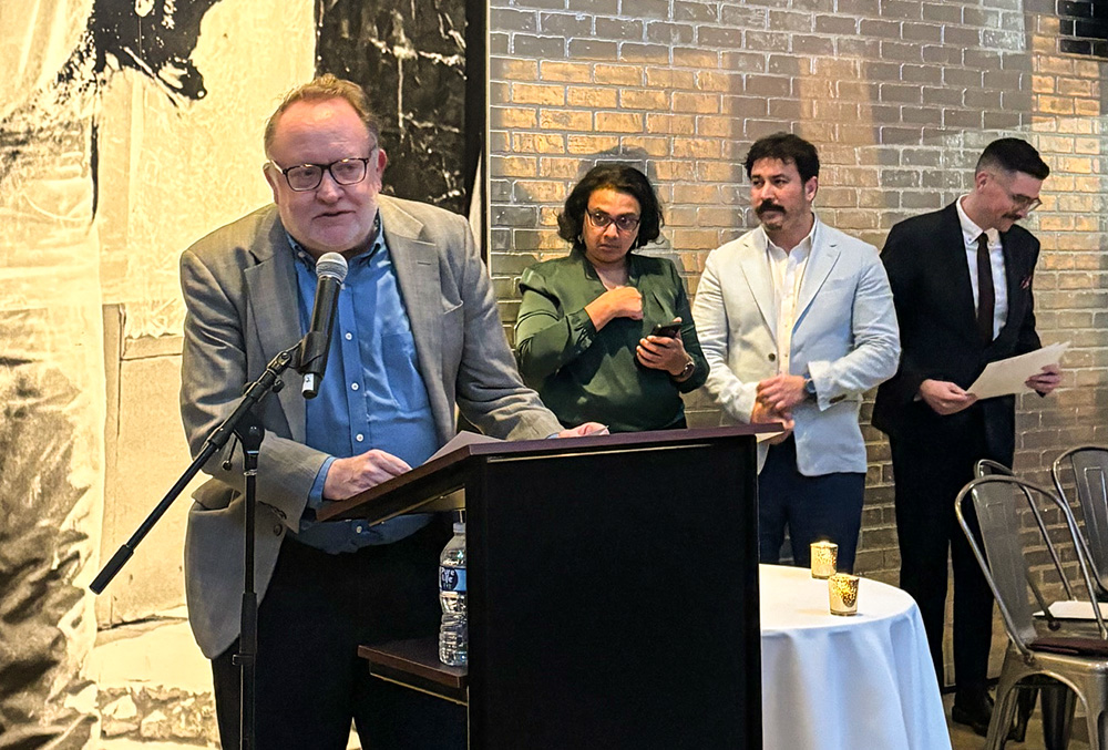 Chris Herlinger, international correspondent for Global Sisters Report, accepts an award from the Religion News Association on behalf of GSR staff for the series "Hope Amid Turmoil" at an April 20 ceremony at the Warhol Museum in Pittsburgh. (GSR photo/Olivia Bardo)