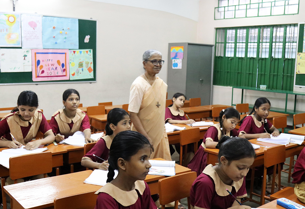Sr. Lourdes Mary Rozario teaches and supervises a class in the Mohammadpur area of Dhaka, Bangladesh. The Congregation of Our Lady of the Missions Sisters started the Green Herald Evening Charity School program for Bihari children in 1982. (Stephan Uttom Rozario)
