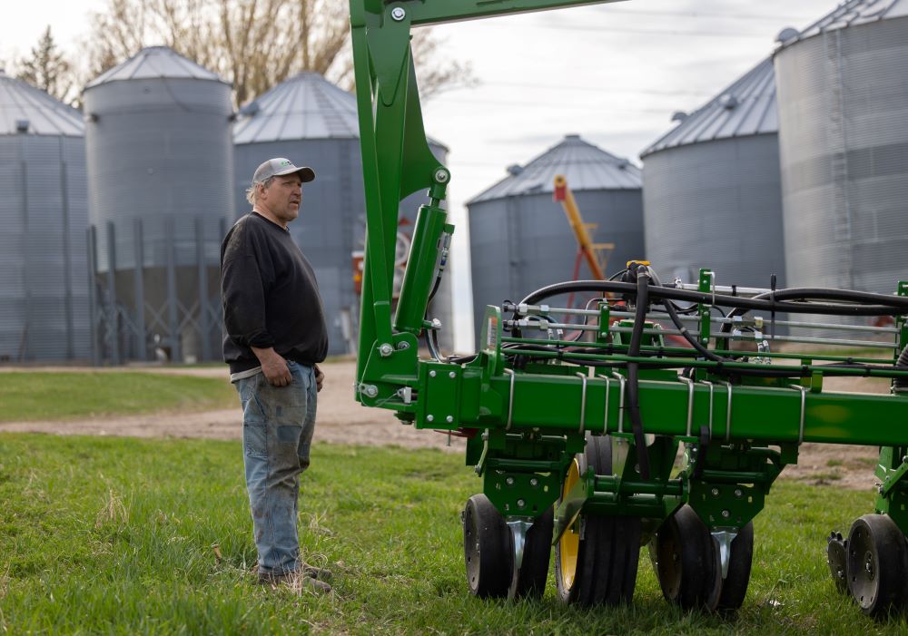 Jim Glisczinski looks over his new planter on his farm near Belle Plaine, Minn., April 15, 2024. Farmers like him can receive material and spiritual support from Catholic Rural Life, which celebrates 100 years in May. (OSV News photo/Dave Hrbacek, The Catholic Spirit)