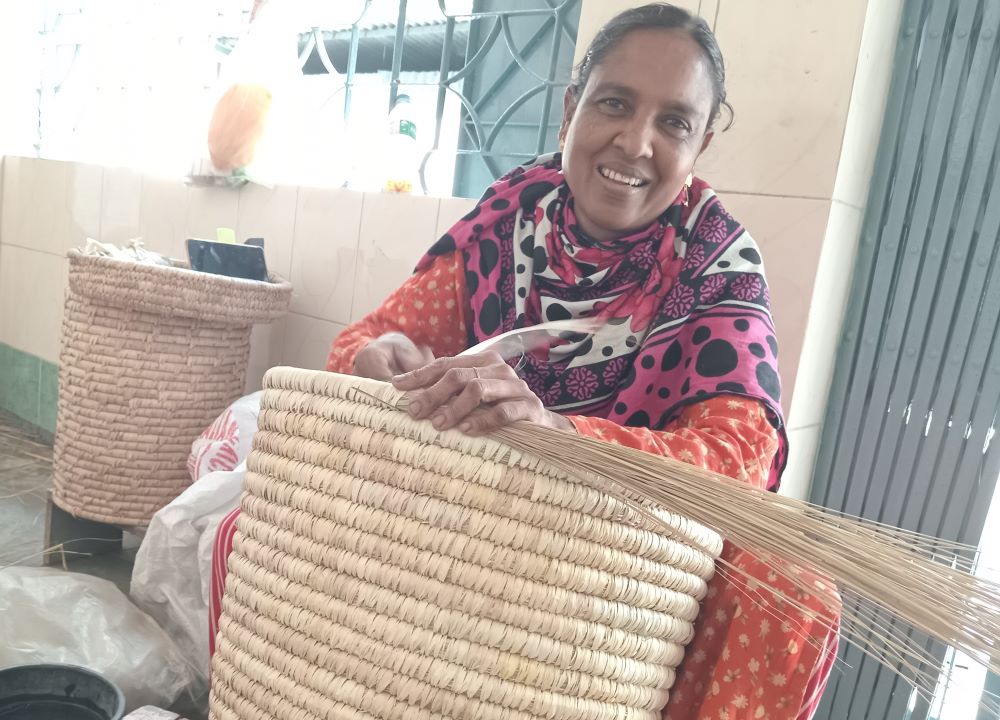 Saphya Khaton makes a laundry basket out of natural materials at Valerian Handicrafts Centre in Jessore, Bangladesh.