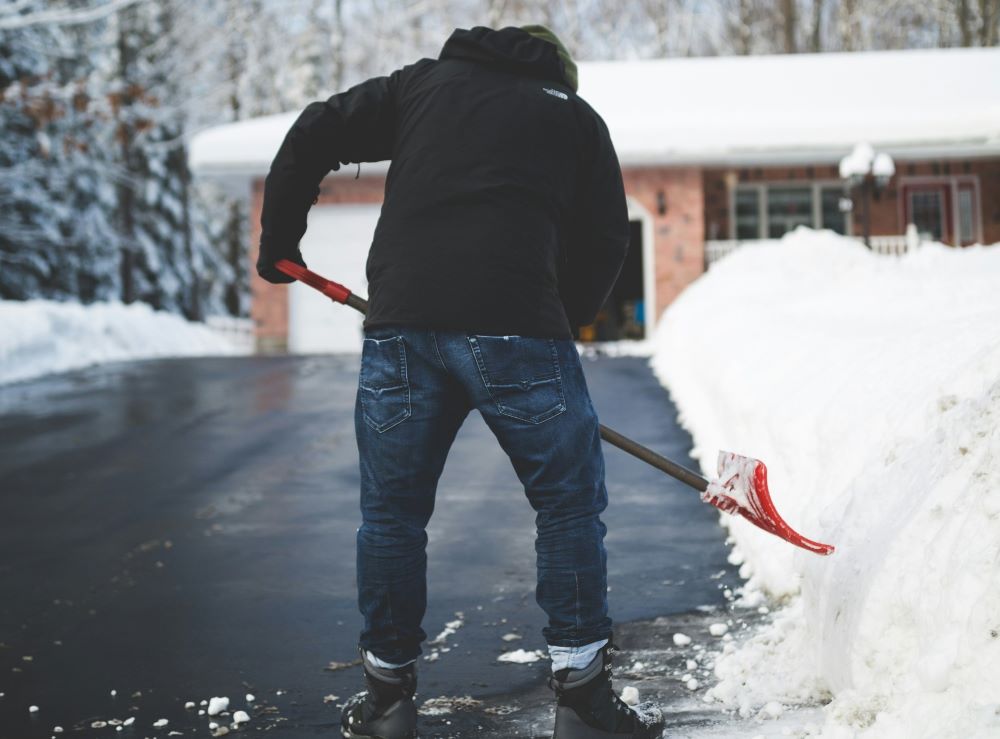 Person shovels snow.