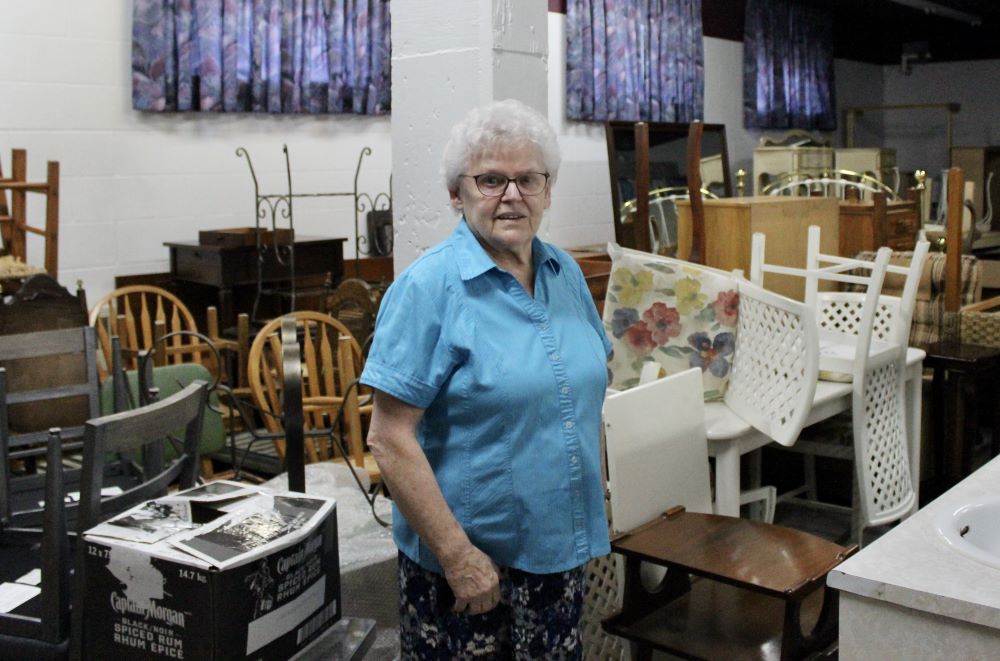 Sr. Gabrielle Servant stands in the basement of the congregation's house, where they store donated furniture for refugees.
