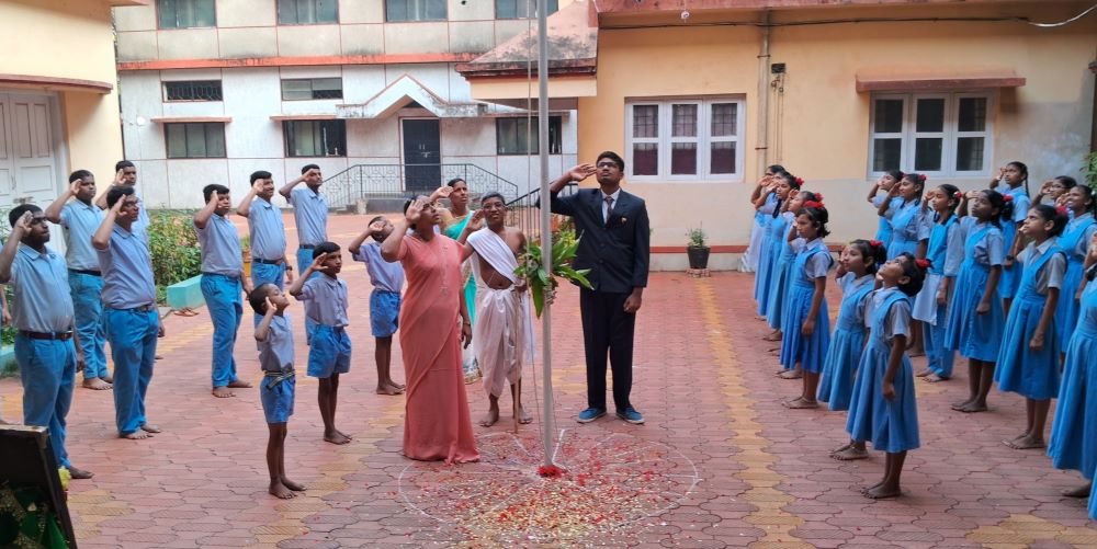 St. Joseph of Chambery Sr. Lynette Lopes, principal, and the students of Asha Niketan salute the Indian flag during India Republic Day celebrations Jan. 26.