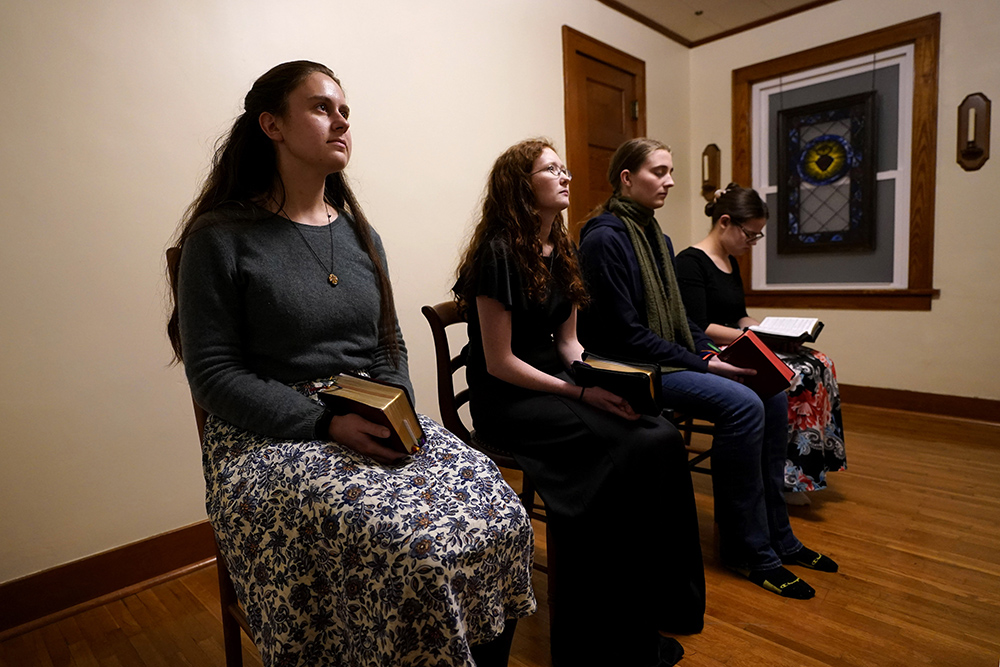 Benedictine College students, from left, Madeline Hays, Niki Wood, Ashley Lestone and Hannah Moore gather for evening prayers in a room which they converted to a chapel in the house they share Dec. 3, 2023, in Atchison, Kansas. (AP/Charlie Riedel)