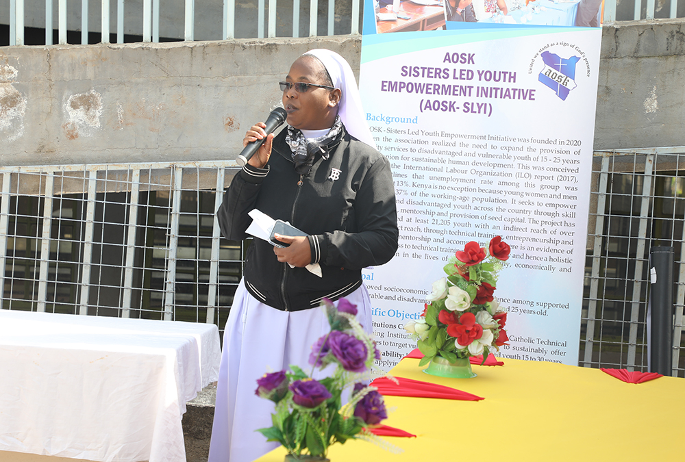 Sr. Mercy Mwayi, program manager of the Sisters' Led Youth Empowerment Initiative of the Association of Sisterhoods of Kenya, addresses a symposium of ministry officials, Catholic technical and vocational institutions, and hundreds of youth attendees who had gathered at St. Charles Lwanga Vocational Training Institute in Kibera, Nairobi, for the forum of the initiative's environmental conservation program. (Wycliff Peter Oundo)