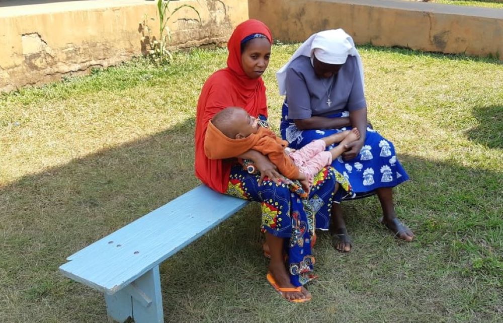 Sr. Felicitas Asoh prays with and counsels a woman and her son, Mohan. Sr. Felicitas Asoh prays with and counsels a woman and her son, Mohan.