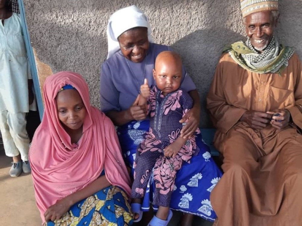 Mohan with his parents and Sr. Felicitas Asoh Mohan with his parents and Sr. Felicitas Asoh