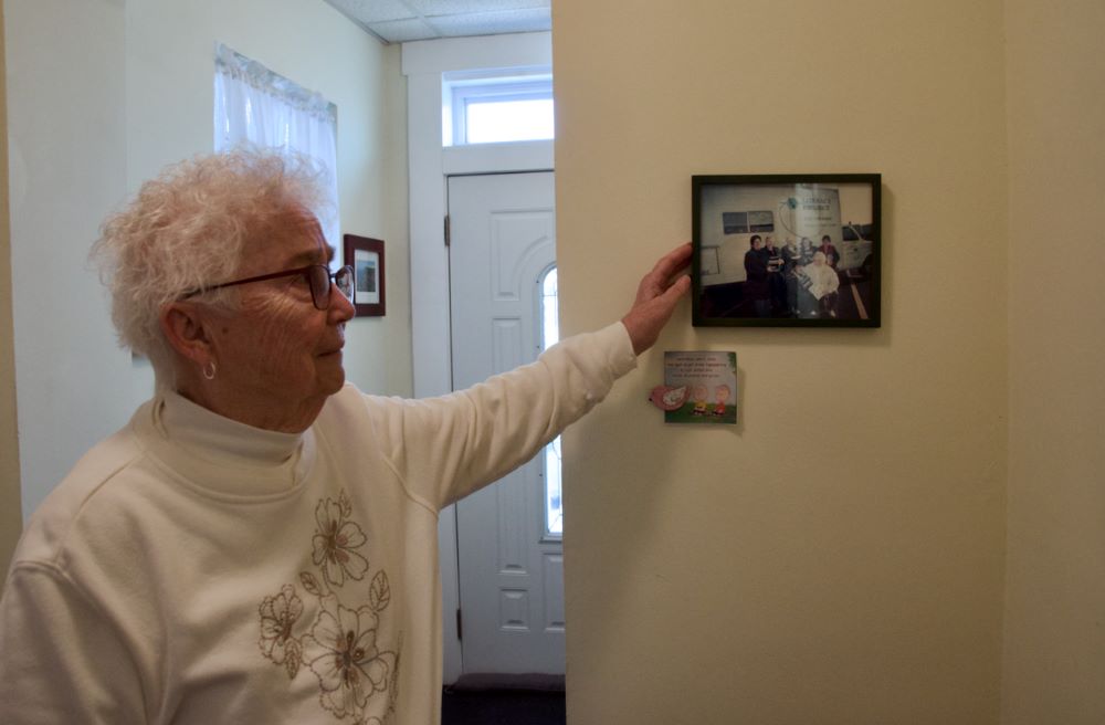 Sr. Marian Behrle shows a photo of the Sisters of St. Joseph Welcome Center's early mission: a van that would visit different sites to serve the Albanian community and teach literacy classes. Behrle is the center's finance and operations coordinator. Sr. Marian Behrle shows a photo of the Sisters of St. Joseph Welcome Center's early mission: a van that would visit different sites to serve the Albanian community and teach literacy classes. Behrle is the center's finance and operations coordinator.