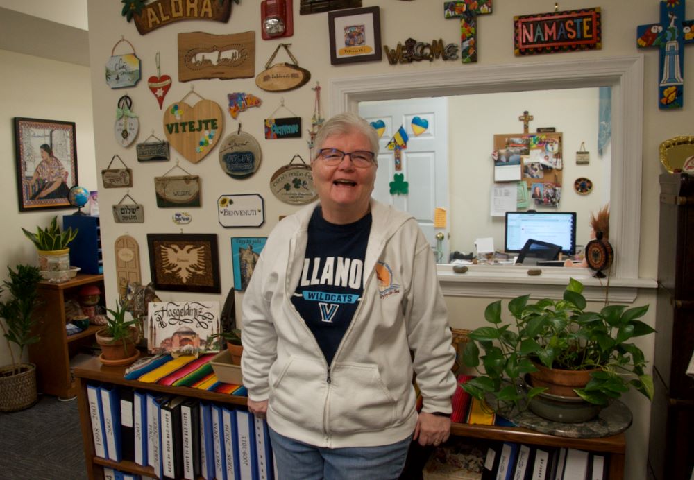 Sr. Pat Madden stands before a wall covered with welcome signs given by clients the Sisters of St. Joseph Welcome Center has helped with literacy and citizenship classes. Sr. Pat Madden stands before a wall covered with welcome signs given by clients the Sisters of St. Joseph Welcome Center has helped with literacy and citizenship classes.