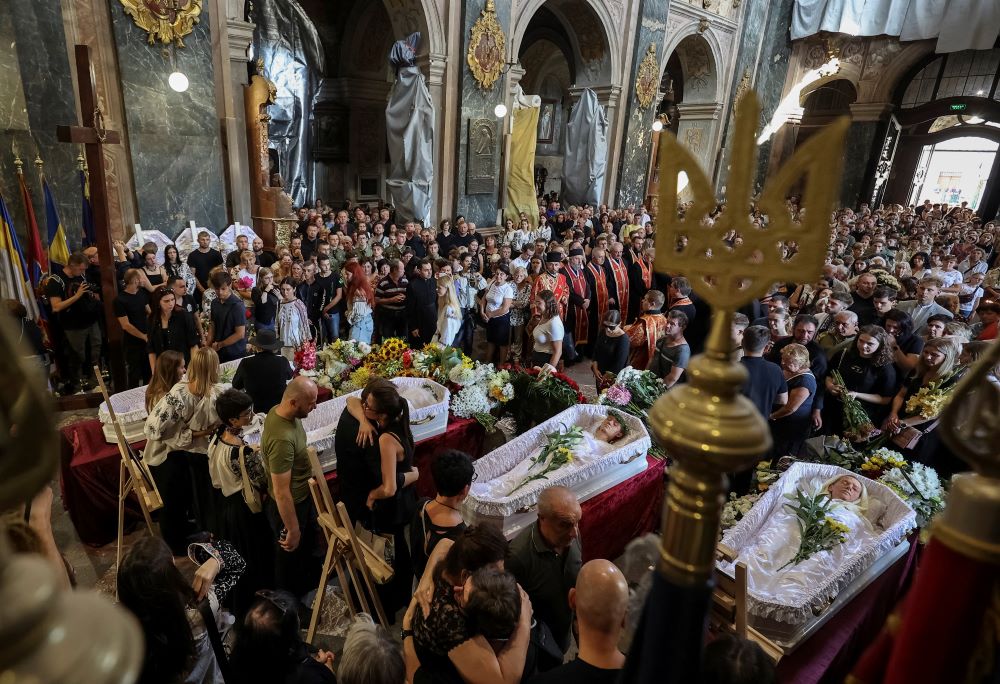 Mourners attend a funeral ceremony in Lviv, Ukraine, Sept. 6 for a woman her three daughters, killed during a Russian airstrike. Mourners attend a funeral ceremony in Lviv, Ukraine, Sept. 6 for a woman her three daughters, killed during a Russian airstrike.