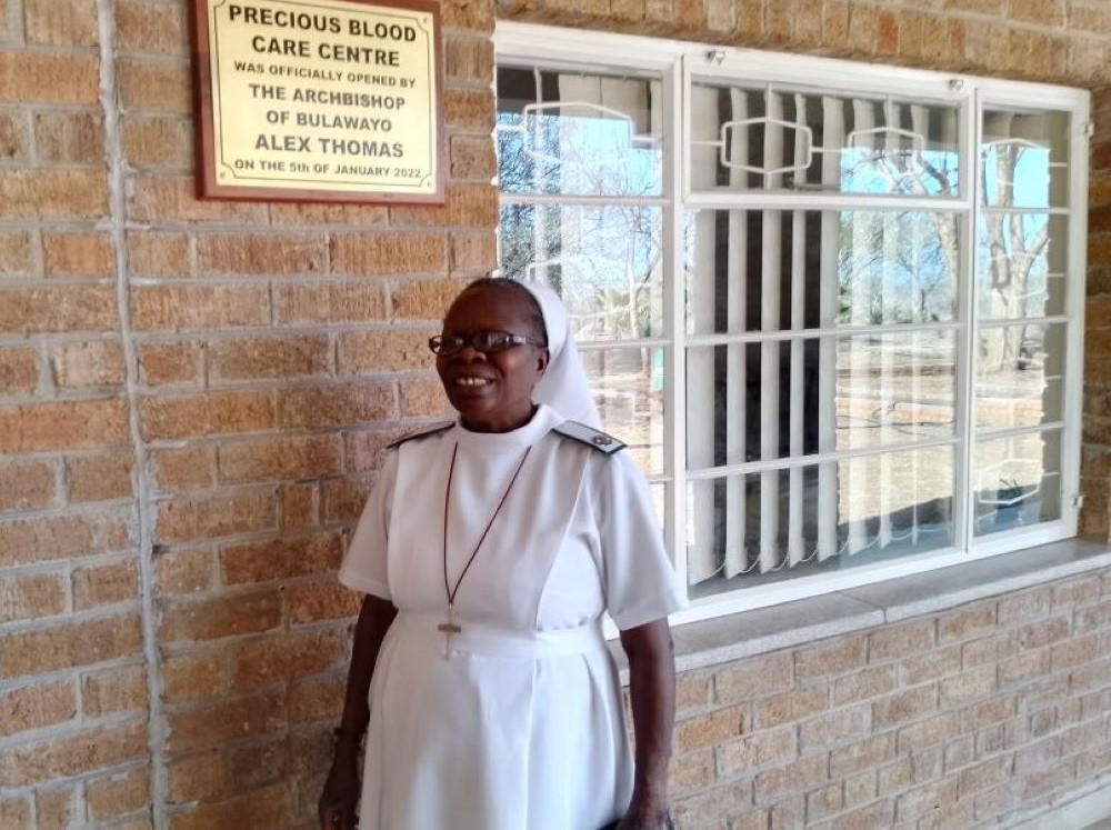 Precious Blood Sr. Caroline Busvumani stands at the entrance of the Precious Blood Care Centre in Bulawayo, Zimbabwe. Precious Blood Sr. Caroline Busvumani stands at the entrance of the Precious Blood Care Centre in Bulawayo, Zimbabwe.