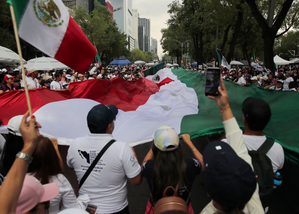 Protesters hold a flag outside the Senate building in Mexico City Sept. 5. Protesters hold a flag outside the Senate building in Mexico City Sept. 5.