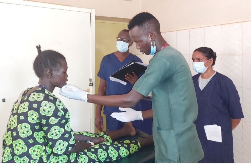 A nurse trainee takes a practical exam. A nurse trainee takes a practical exam.