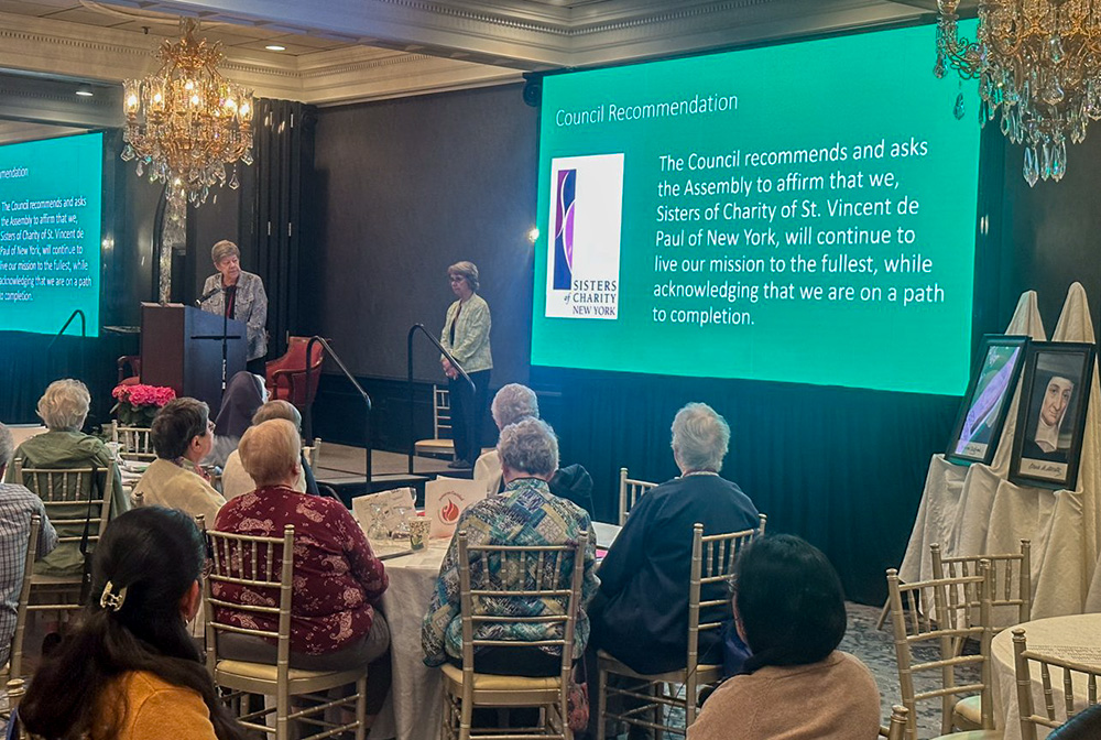 Sr. Donna Dodge, president of the Sisters of Charity of New York, reads the executive council's recommendation on the congregation's "path to completion" at their 2023 general assembly. Delegates to the assembly voted unanimously April 13, 2023, to stop recruiting or accepting new members and begin a "path to completion" while continuing to live their mission to the fullest. (OSV News/Courtesy of the Sisters of Charity of New York)
