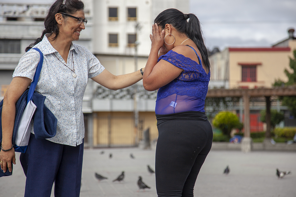 Sr. Angélica Segoviano, an Oblate of the Most Holy Redeemer, visits Wendy Cadina a few times a month at the park where Cadina loiters to sell sex. They talk about Cadina's life and children, and Segoviano sometimes talks about job opportunities outside of prostitution. (Courtesy of Lisa Kristine)