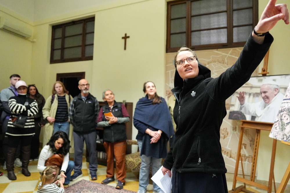 Mercy Sister Celeste Mary Poche, a staff member of the Bishops’ Office for U.S. Visitors to the Vatican, gives a brief orientation at the Casa Santa Maria of the Pontifical North American College in Rome Feb. 4, 2025. The sister foregrounded pointing out of frame, in background is small group assembled in classroom-like setting.