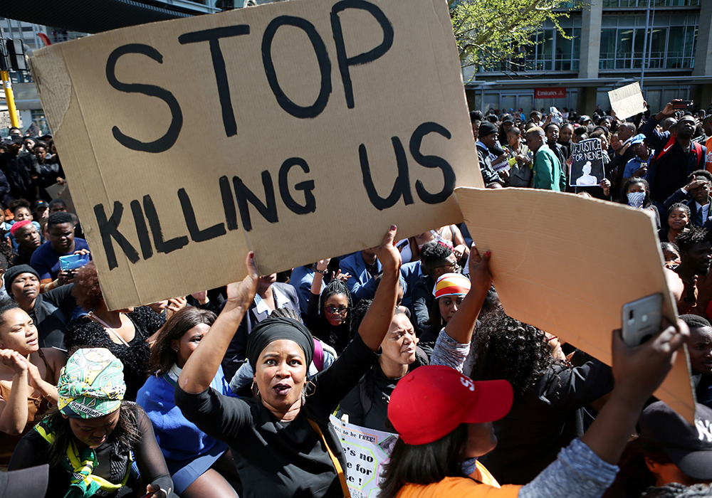 A woman holds a sign as demonstrators gather Sept. 4, 2019, at the World Economic Forum on Africa in Cape Town during a protest against gender-based violence. (CNS/Reuters/Sumaya Hisham)